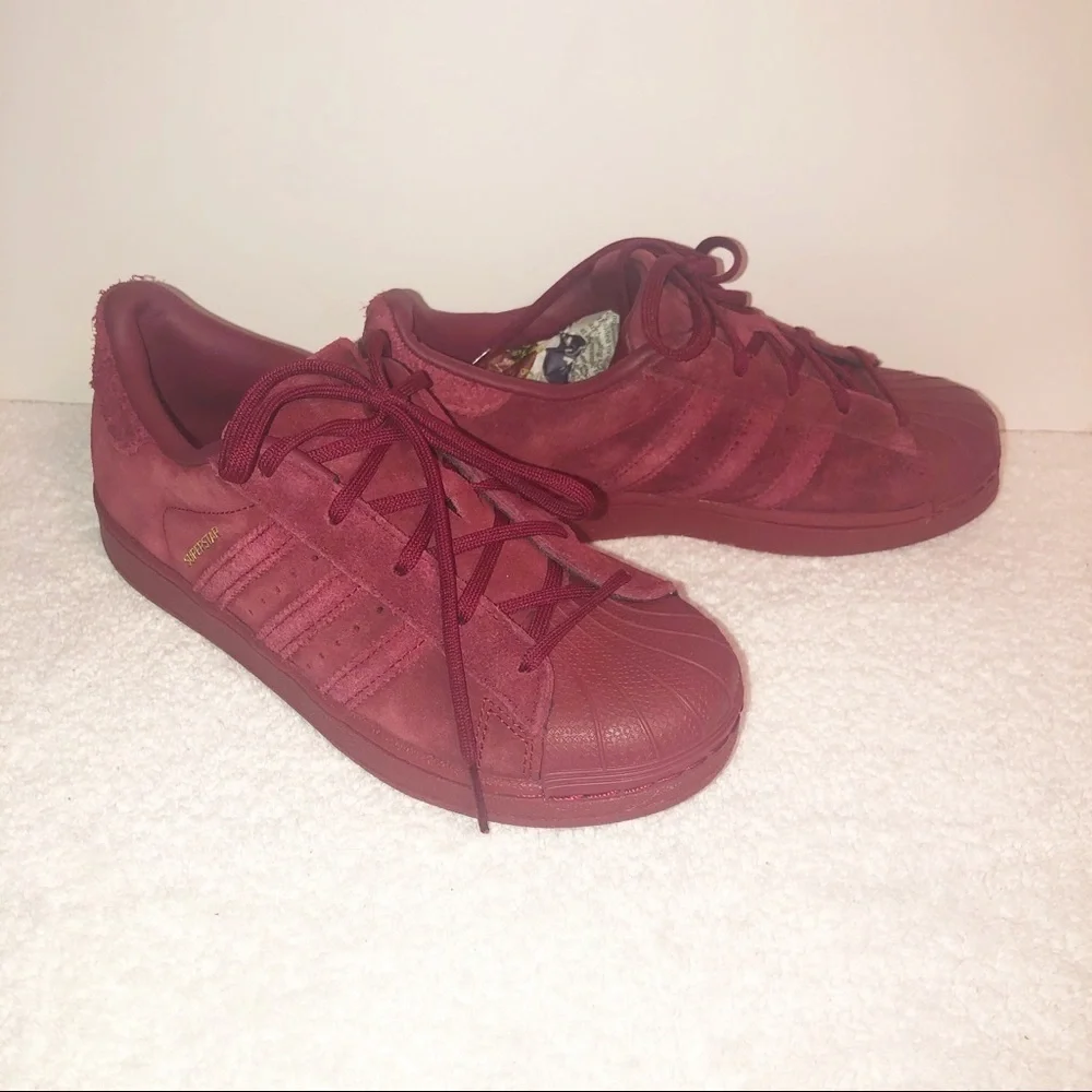 Adidas superstar suede burgundy shell toe sneaker.